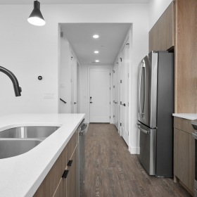 Kitchen Spacious and well lit kitchen with wood flooring and stainless steel appliances